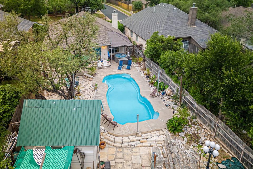 Welcome to your own private Backyard Oasis. Spa jets in pool bench seats & separate hot tub. Natural gas grill, oversized hammock for two, heated pool. Could it get any better?! Come, dive in ️