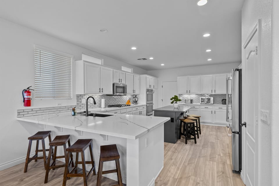 A large and very well equipped kitchen with plenty of counter seating for conversations.