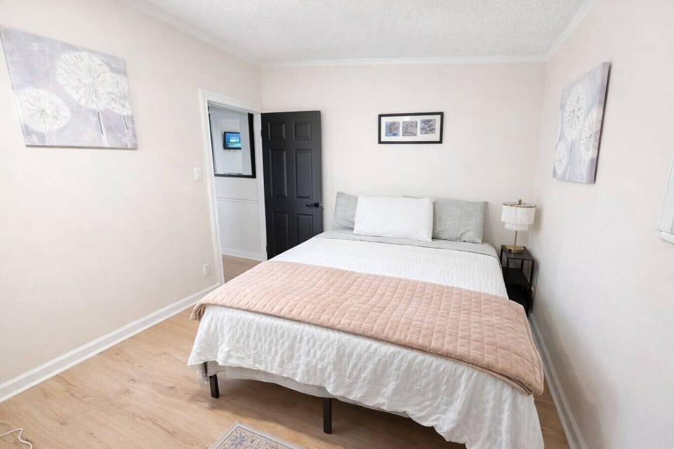 This inviting second bedroom features a comfortable queen-sized bed with room-darkening shades for a peaceful night`s rest, along with a dedicated TV and full climate control to ensure your stay is perfectly relaxing.