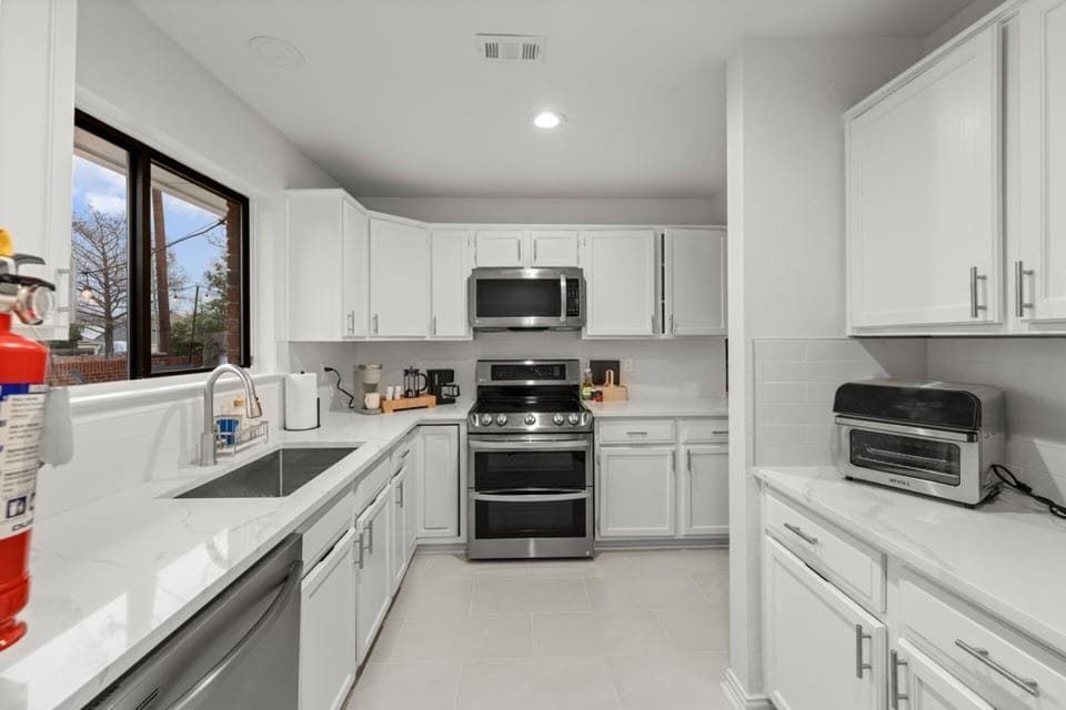Modern appliances and generous counter space make it easy to prepare meals, brew coffee, and settle into a comfortable daily rhythm.