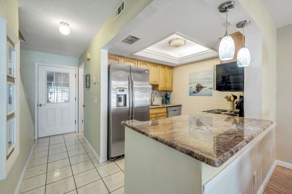 The updated kitchen offers a modern, functional space designed for easy meal prep during your Flagler Beach stay