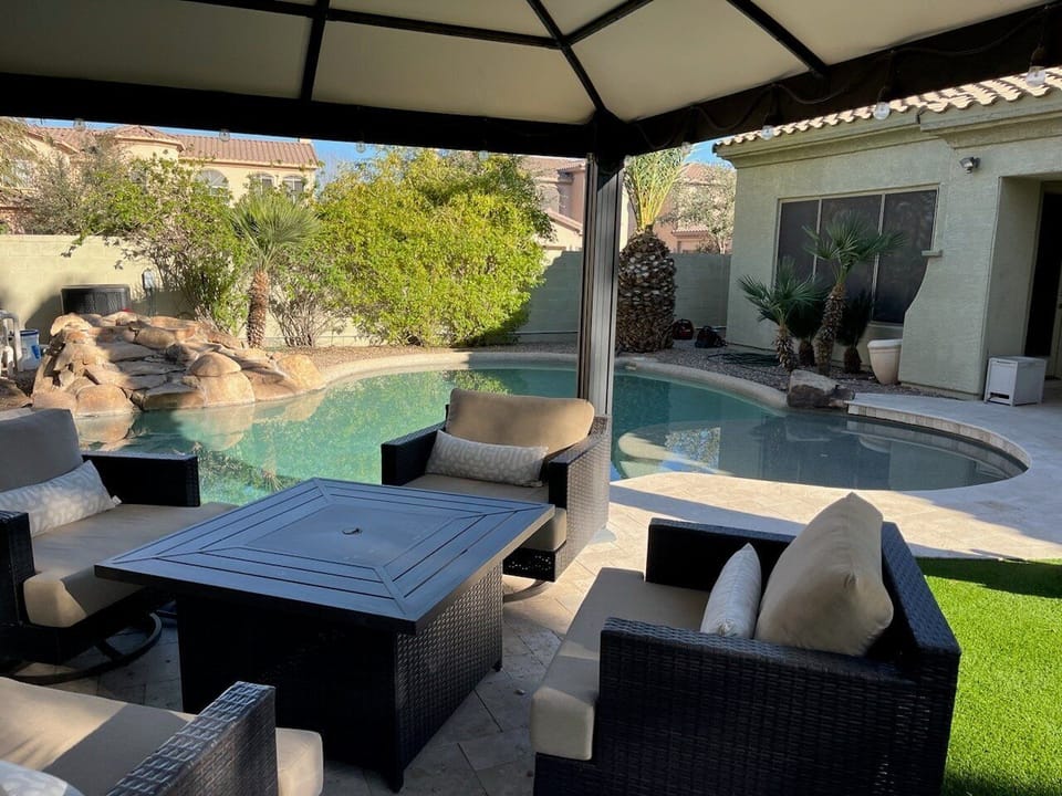 Lovely 5 BR, 3.5 BA home with heated pool, waterfall, covered patio and propane fire pit.