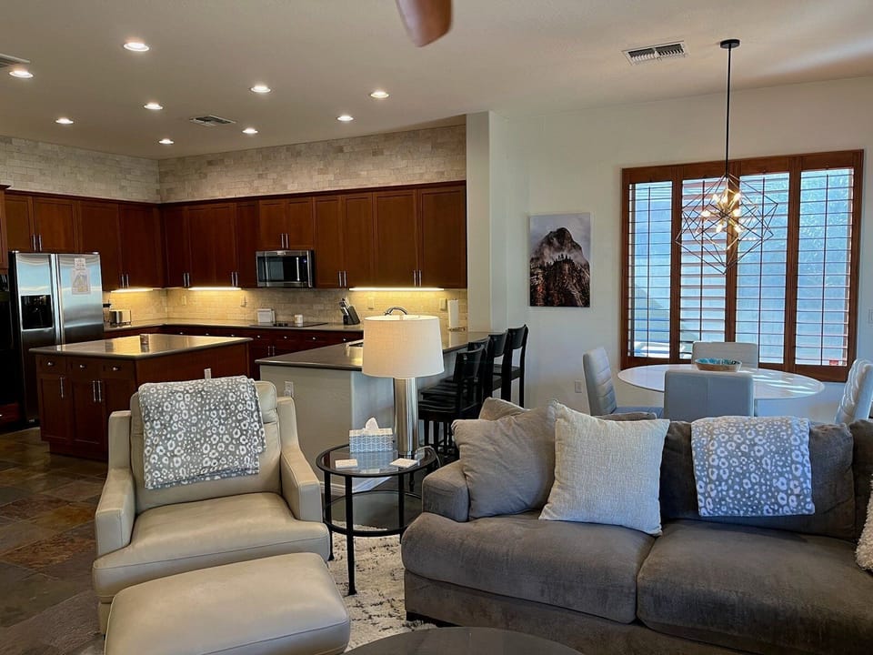 Open concept great room includes a kitchen with eating area and comfortable sitting area.