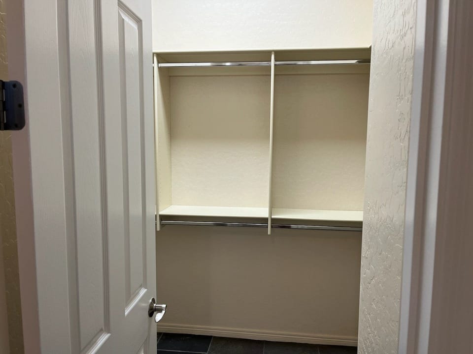 Unpack your belongings in the primary suite walk-in closet.