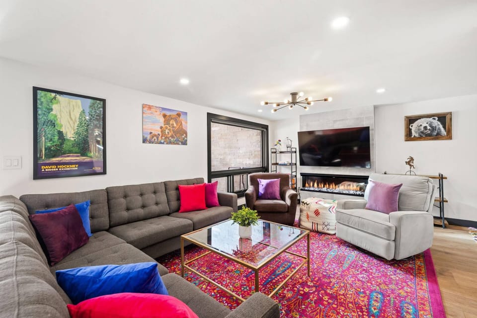 This cozy and vibrant living room with electric fireplace and smart tv is perfect for relaxing after your mountain adventures!