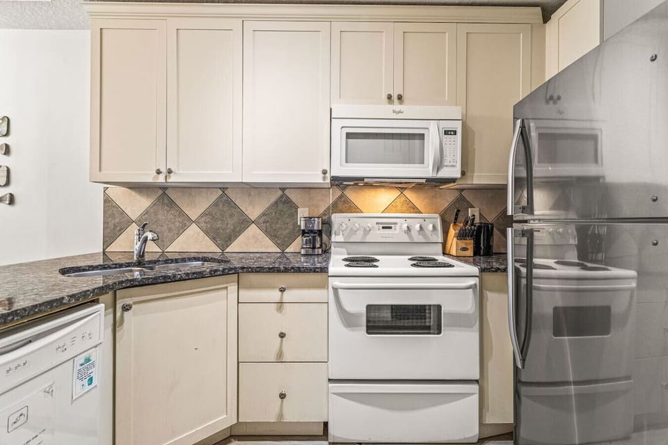 Kitchen set with all of the amenities needed to create meals.