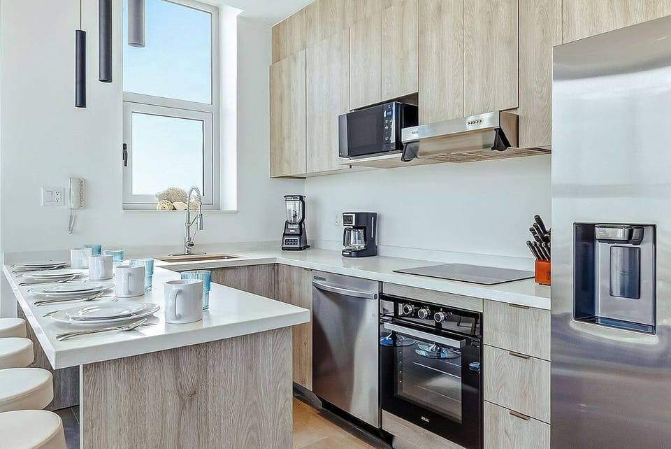 Your fully equipped kitchen features modern appliances and a breakfast bar where you can start each day with coffee and conversation.