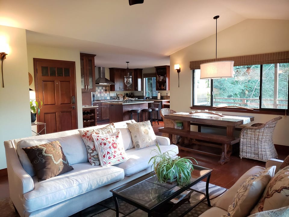 The open-concept living space combines comfort and style, where plush sofas invite relaxation while rich wood cabinetry frames your fully equipped kitchen.