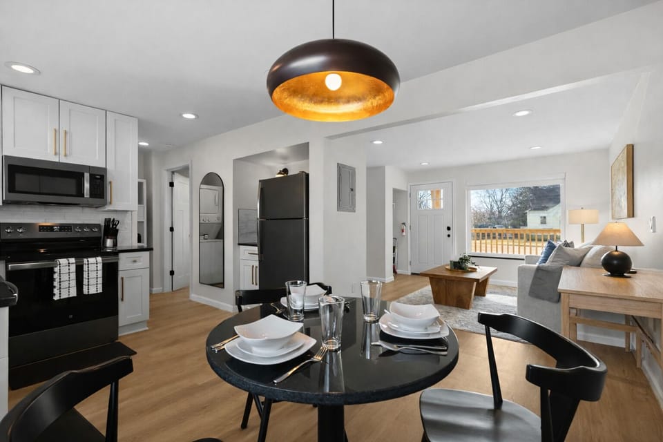 Open-concept dining and kitchen area with modern finishes, warm lighting, and seamless flow into the living space—perfect for meals, entertaining, and relaxing together.