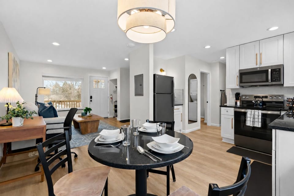 Open-concept kitchen, dining, and living area with modern finishes, cozy seating, and natural light—perfect for relaxing, dining, and entertaining.