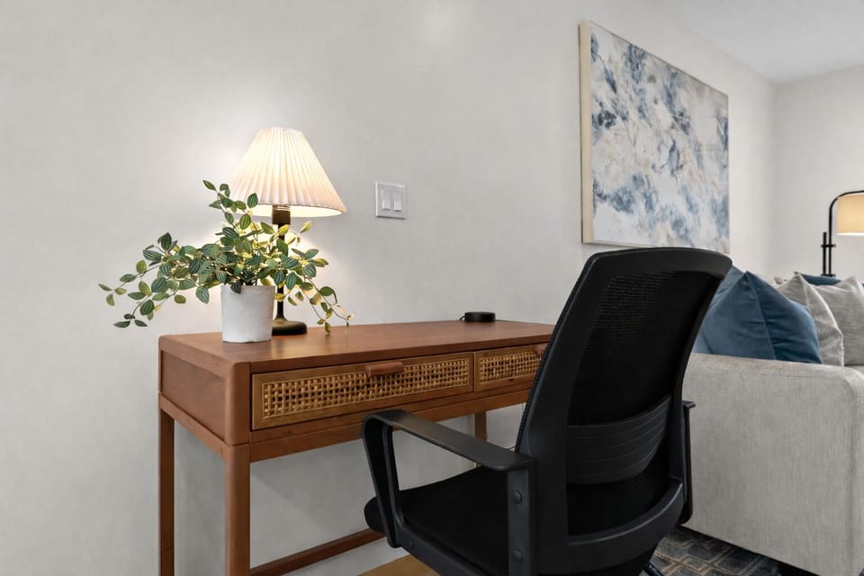 Dedicated workspace with comfortable seating, warm lighting, and a quiet setting—ideal for remote work or catching up on emails.
