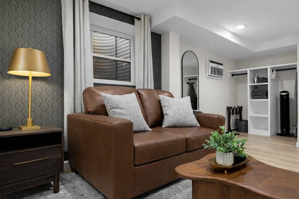 Cozy lounge area with comfortable leather seating, warm accent lighting, and stylish details—an inviting spot to relax, unwind, and feel right at home.