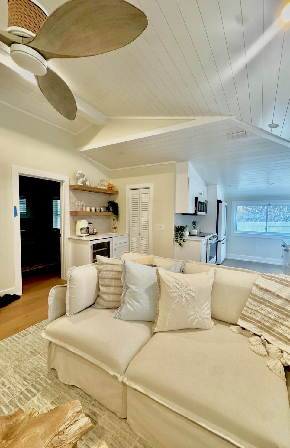 Living room with bedroom one view and wet bar. 