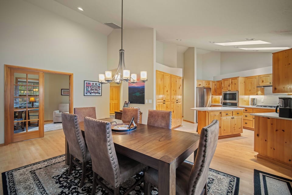 Gather around your spacious dining table where warm wood tones create the perfect backdrop for memorable meals with loved ones.
