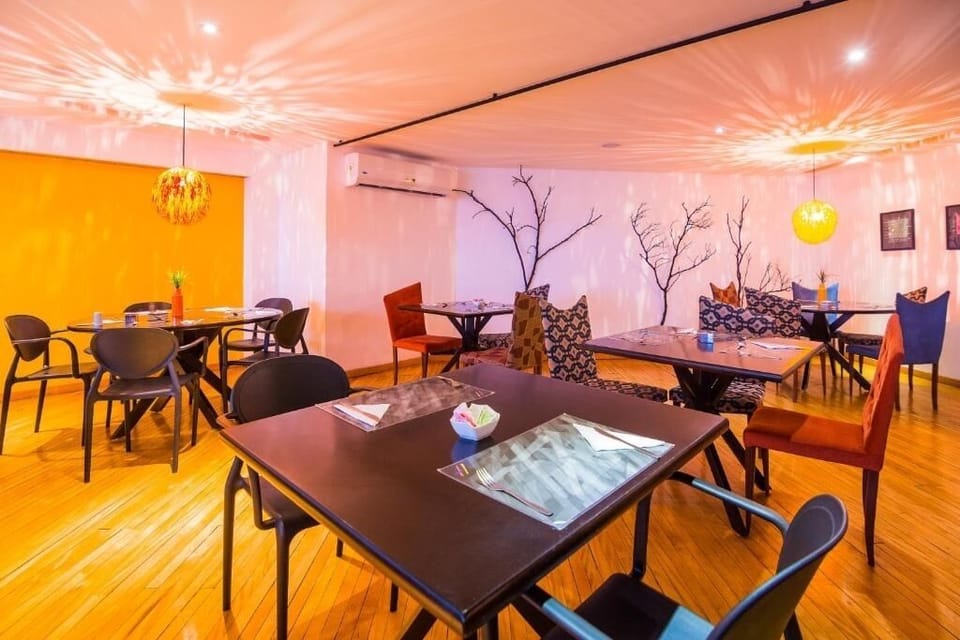 Unwind over cocktails at cozy tables under warm lighting.