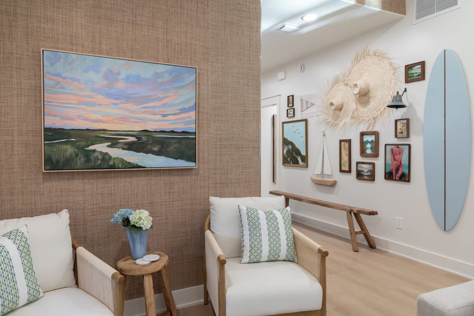 Living room with view of gallery wall featuring local artists