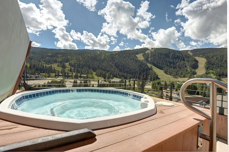 Unwind in the bubbling hot tub with sweeping mountain views.