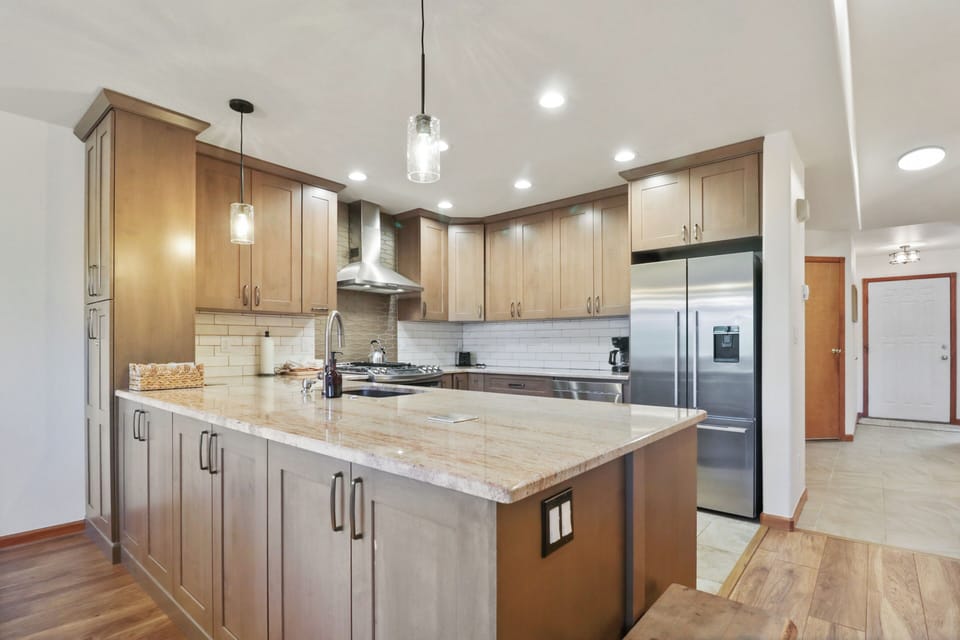 Your gourmet kitchen awaits with granite counters, stainless appliances, and warm wood cabinetry for memorable meal prep.