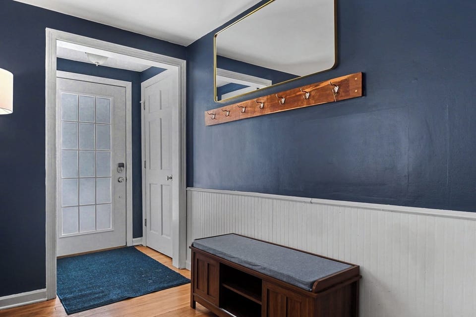 Main entryway greeted by a shoe rack/bench