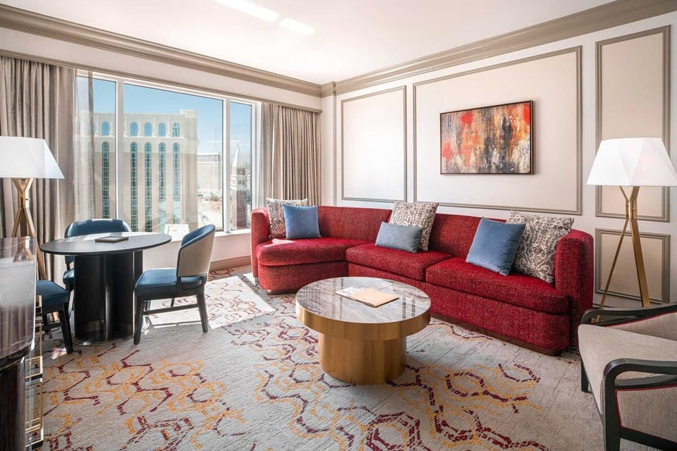 Lounge comfortably by the window with skyline views and seating.