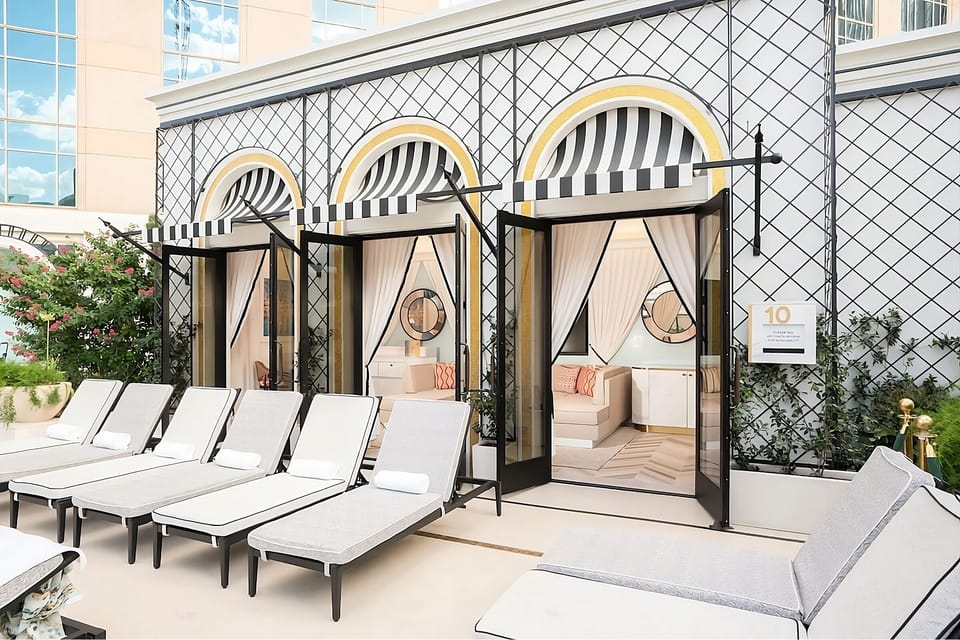 Lounge poolside in a private cabana with breezy curtains.