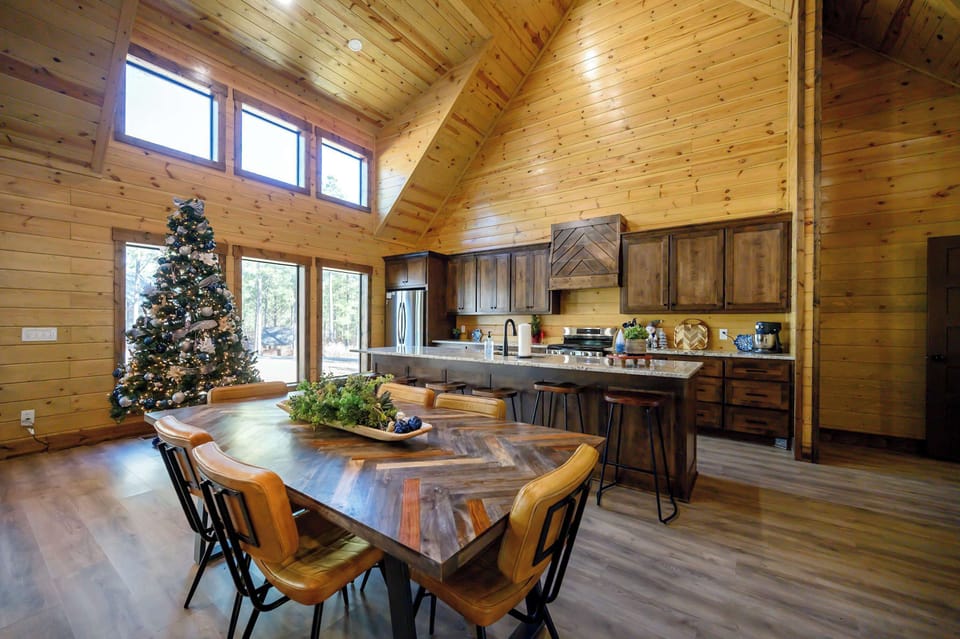 Open-Concept Cabin Kitchen w/ Island Seating, Dining Table & Vaulted Ceilings