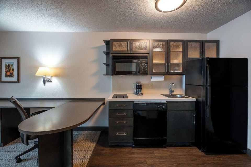 Enjoy quick meals with fridge, microwave, and compact cooktop.