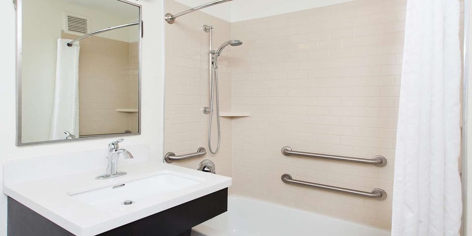 Refresh comfortably with bright vanity lighting and accessible shower.