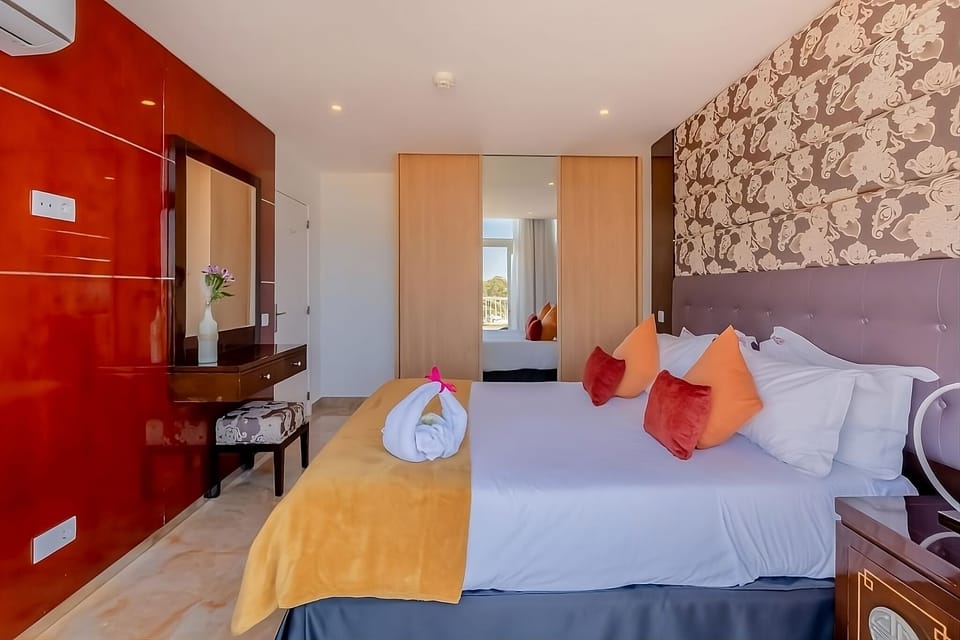 Unwind in a stylish bedroom with crisp linens and calm lighting.
