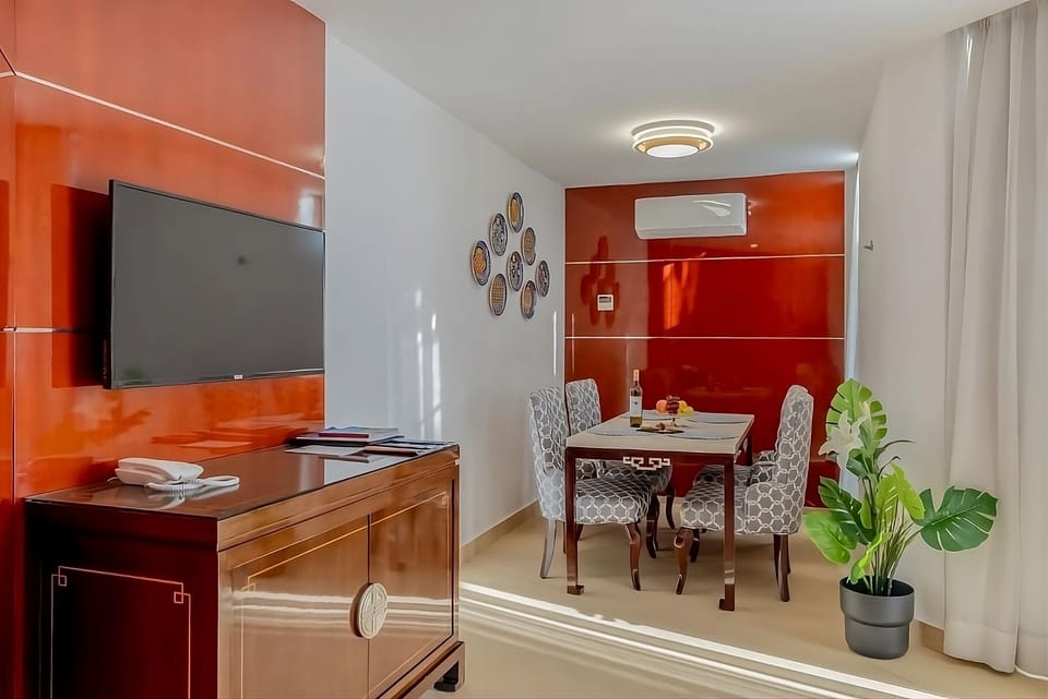 Relax together in the stylish lounge with TV and AC.