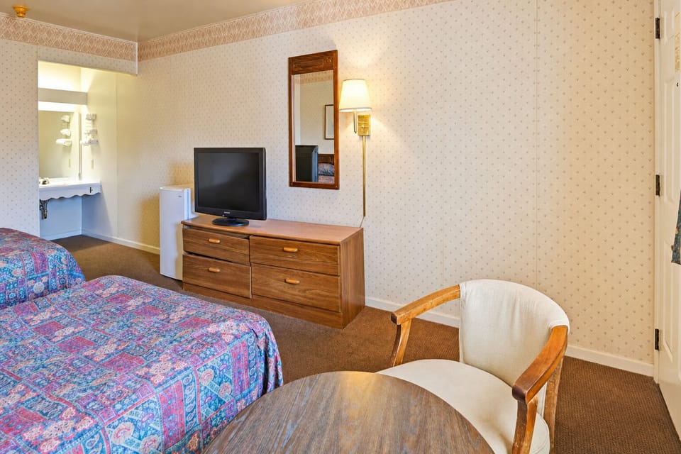 Unwind in a cozy room with TV and seating.