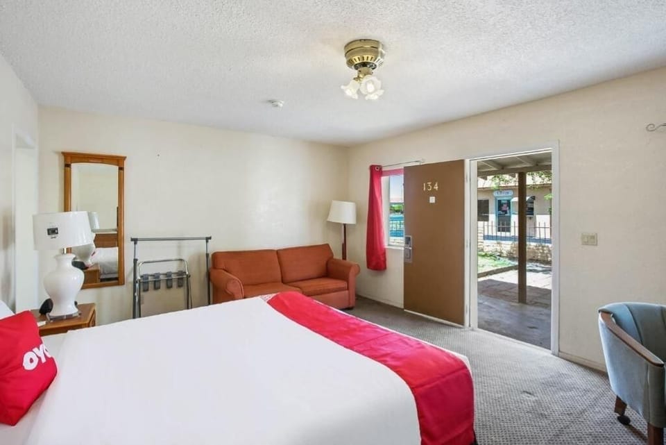 Relax in a spacious room with bed and cozy sofa.