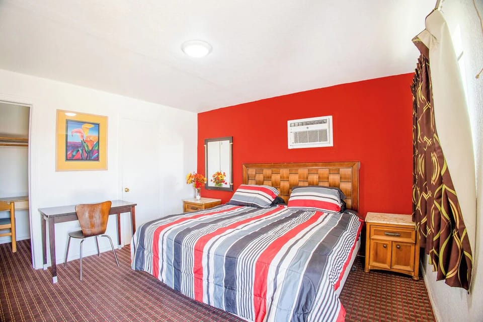 Unwind in a bright room with bed and workspace.