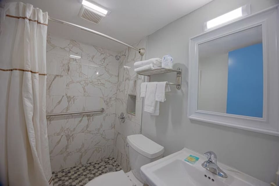 Refresh after adventures in this bright, marble-tiled walk-in shower.