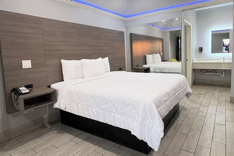 Drift off in soft linens under calming, modern accents.