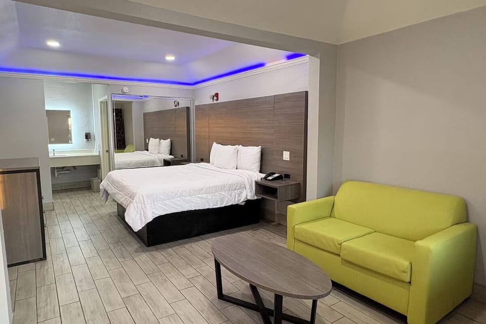 Unwind on the plush bed and lounge beneath ambient lighting.