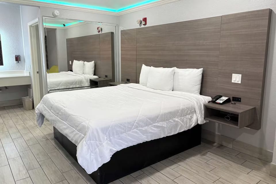 Recharge in a sleek room with convenient bedside essentials.