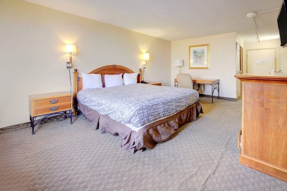 Stretch out in a roomy king retreat with warm lighting.