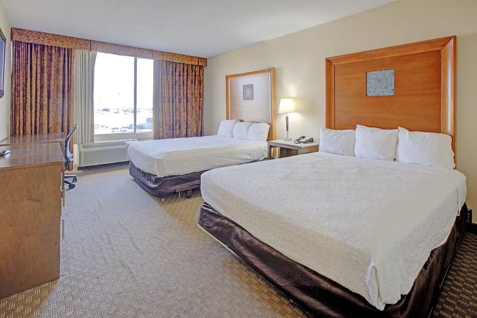 Recharge in a comfortable room with workspace and bright window.