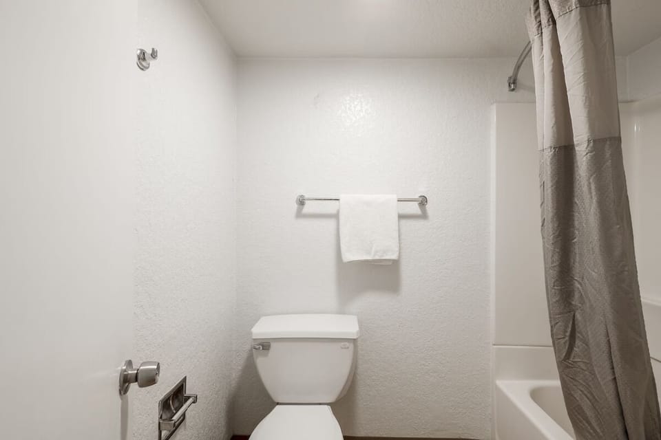 Freshen up quickly with a simple tub-and-shower combo bathroom.