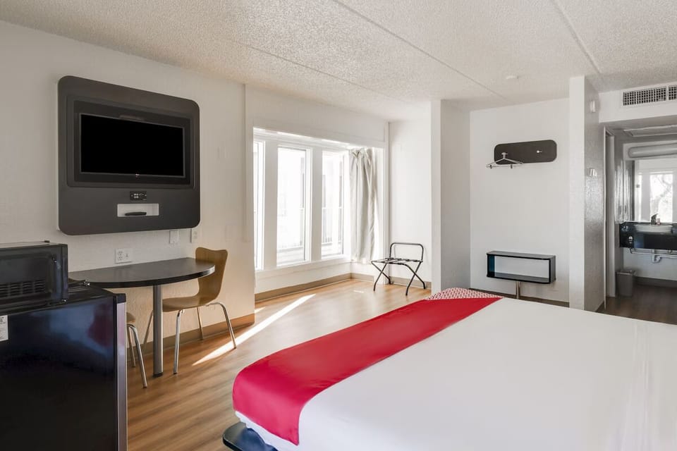 Kick back with wall-mounted TV and a cozy dining nook.