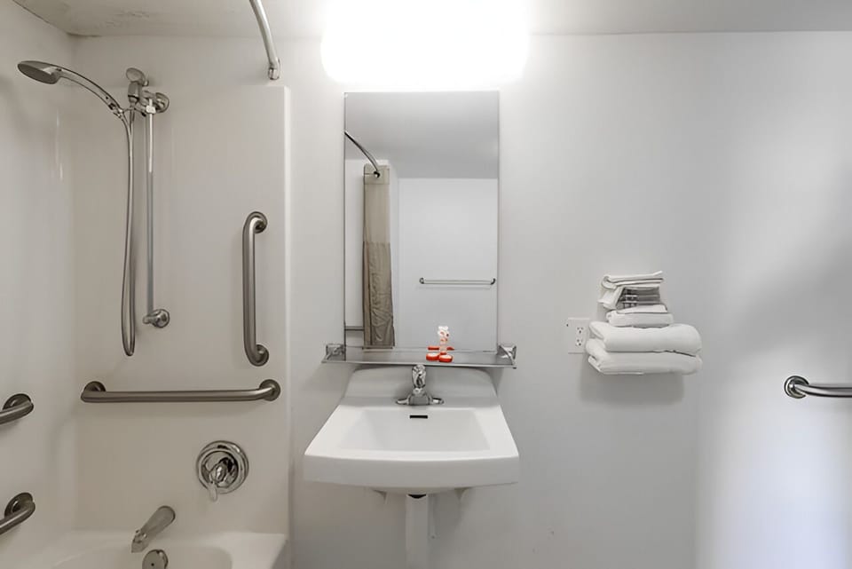 Refresh at the bright vanity with clean towels ready for you.