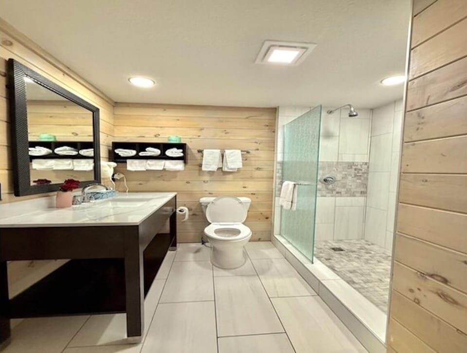 Refresh in a modern bath with bright lighting and walk-in shower.