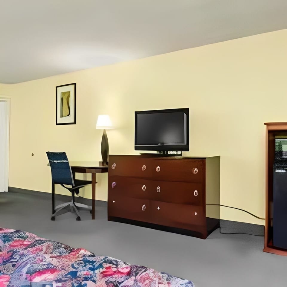 Unwind in a cozy room with TV and workspace.