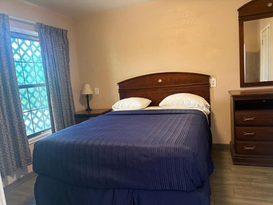 Unwind in a cozy bed with soft lighting and privacy.
