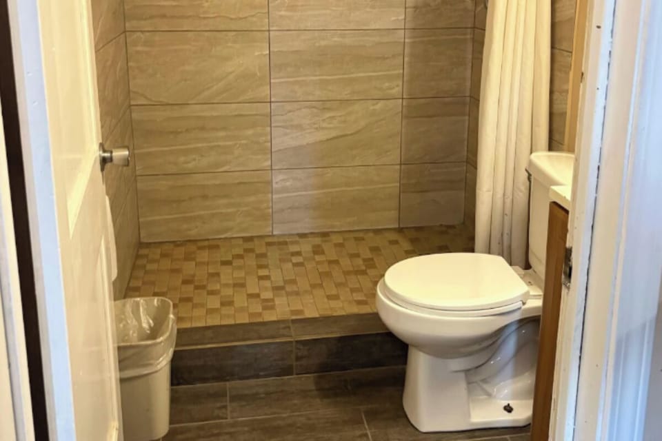 Step into a spacious shower area for an easy rinse.