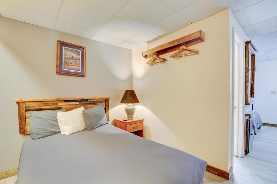 Settle in comfortably with bedside lamp and handy hanging space.