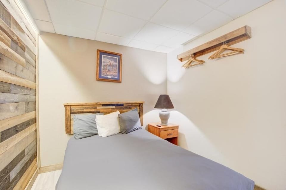 Unwind into a cozy bed with warm rustic accents.
