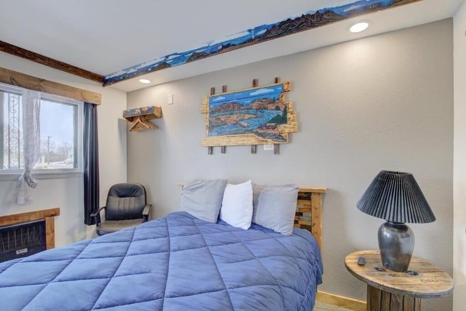 Sink into plush comfort beneath charming rustic mountain-inspired artwork.