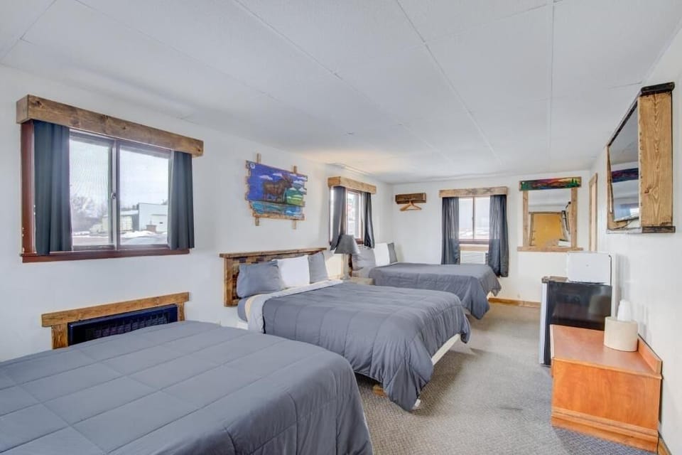 Unwind together in a bright room with three cozy beds.